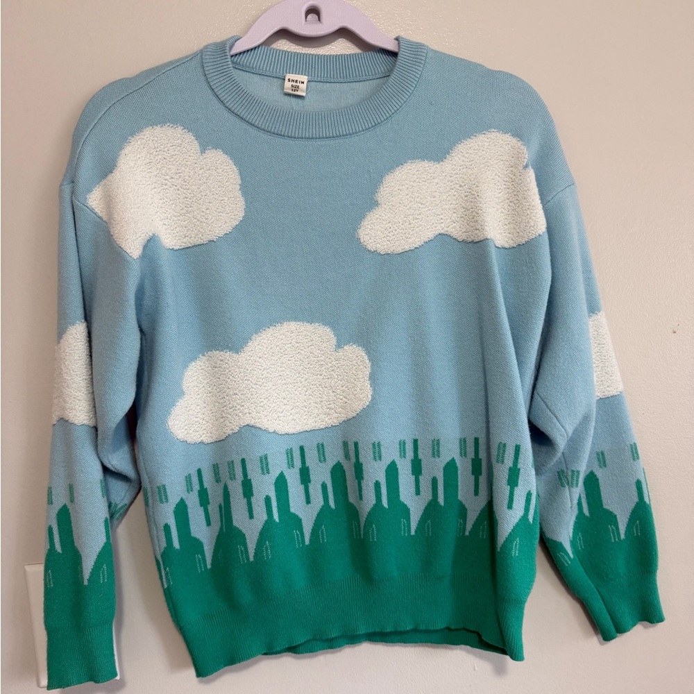 Blue Sweater with Cloud and Green Tree Design